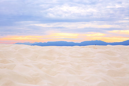 beige sand under cloudy sky thumbnail