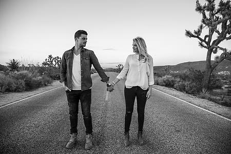 grayscale photo of man and woman holding hands thumbnail