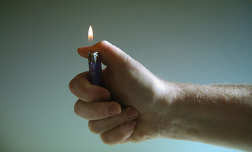 person holding disposable lighter thumbnail