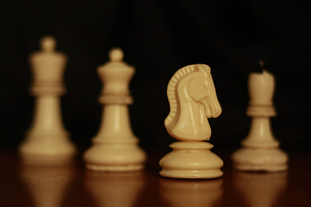 four brown chess pieces thumbnail