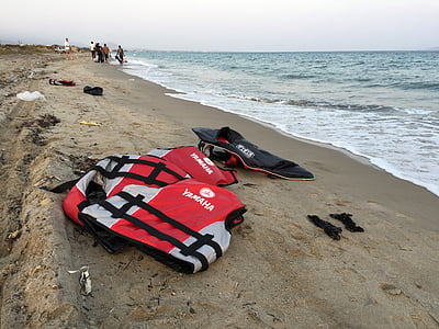 two red-and-white Yamaha life vest on seashore at daytime thumbnail