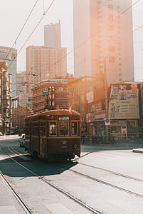 brown tram on road near buildings thumbnail