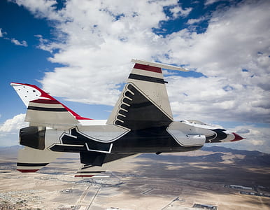 white, red, and black fighter jet flying on sky during daytime thumbnail