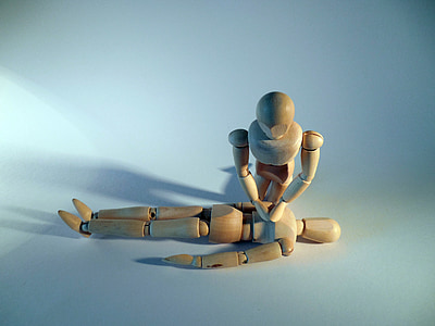 two brown wooden action figure on white surface thumbnail