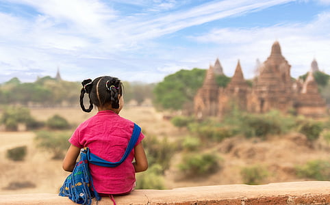 girl wearing pink shirt seating on clif thumbnail