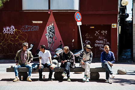 five man sitting on gray concrete bench near street thumbnail