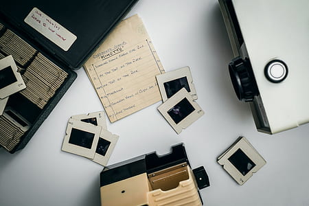 gray and black projector on white wooden frame thumbnail