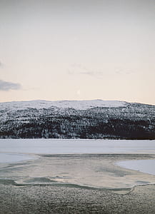 snow covered mountain under gray sky at daytime thumbnail