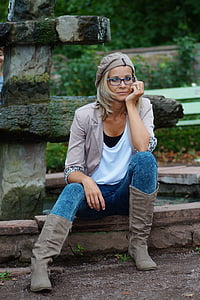woman wearing gray jacket and blue denim pants thumbnail