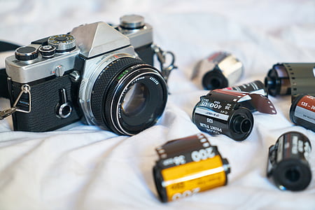 gray and black filmed camera with film cartridges thumbnail