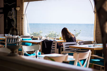 woman sitting on chair beside table thumbnail