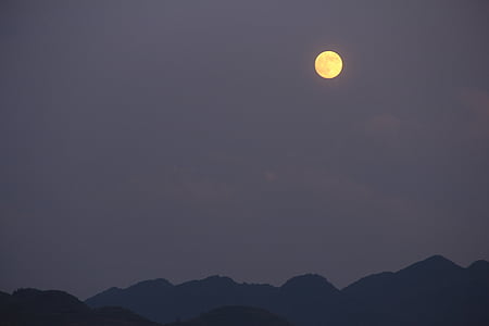 mountain view under cloudy sky and moon thumbnail