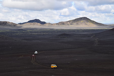 yellow van on brown desert under white sky during daytime thumbnail