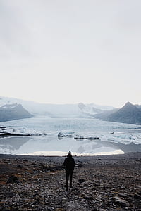 person standing near body of water thumbnail