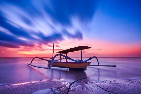 Brown Blue and White Wooden Boat during Orange Sunset thumbnail