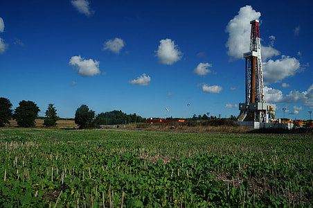 white, brown, and red metal tower under cloudy blue sky thumbnail
