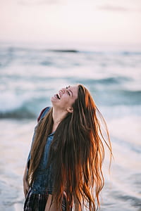 woman laughing near body of water thumbnail