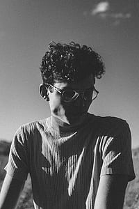 grayscale photography of man wearing turtleneck shirt thumbnail