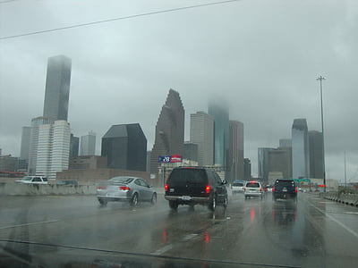 cars traveling on road while raining thumbnail