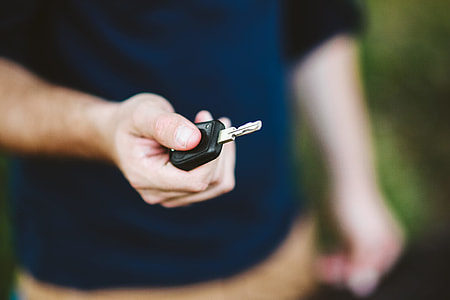 Young man holding car keys thumbnail