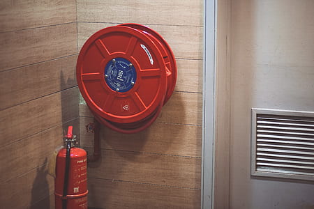Red Fire Extinguisher Beside Hose Reel Inside the Room thumbnail