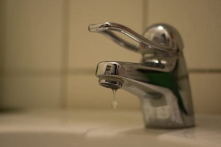 time lapse photography of slightly opened faucet thumbnail