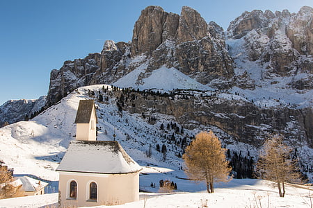 aerial photography of white and brown concrete building near snow-covered mountain during daytime thumbnail