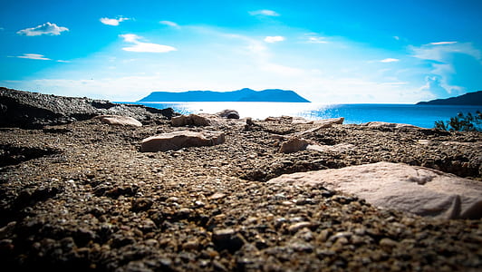 photo of rock near body of water thumbnail