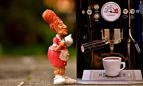woman figurine holding pot beside espresso maker thumbnail