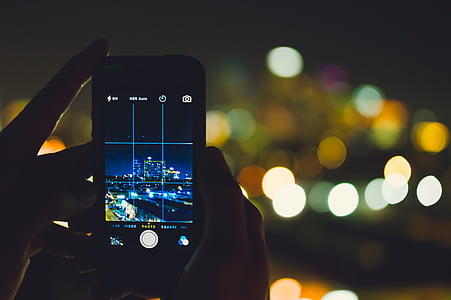 silver iPhone 6 showing building with background of bokeh lights thumbnail