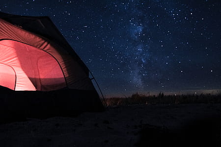 light red dome camping tent under blue starry night thumbnail