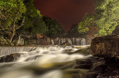waterfalls surrounded by tall trees thumbnail