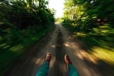 selective focus photography of person wearing brown sneakers thumbnail