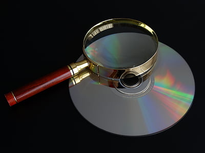 brown handle magnifying glass on top of disc thumbnail