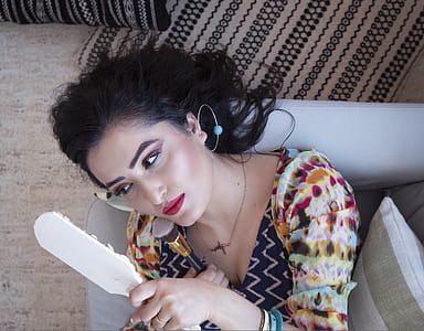 Woman Lying On Sofa Holding Mirror thumbnail