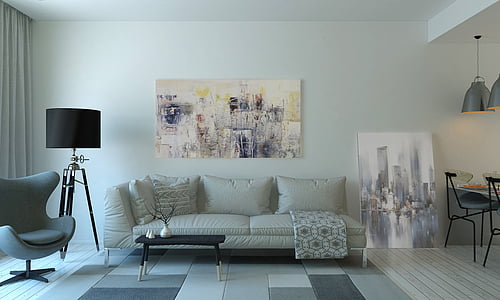 white leather sofa in front of painting on wall thumbnail