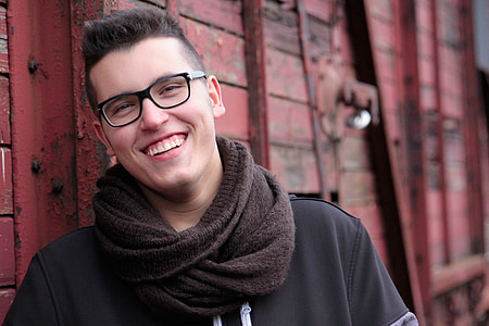 man wearing brown scarf and black shirt thumbnail