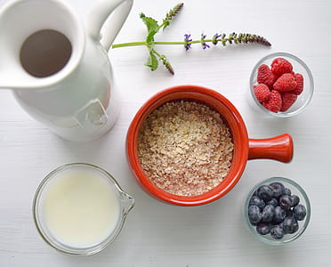 flat lay photo of red mug, white pitcher, and clear glass containers thumbnail
