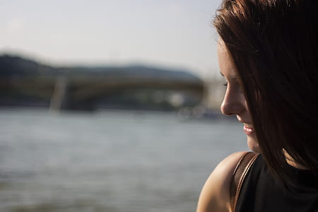 Close Up Photography of Side View Angle of a Woman Smiling Near Seawater during Daytime thumbnail