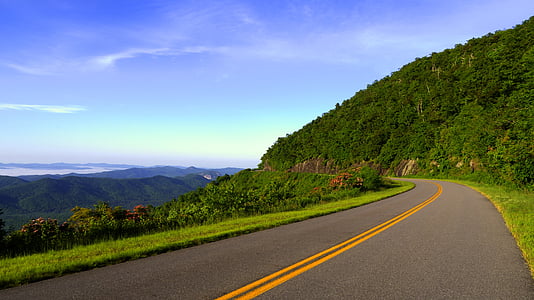 empty winding road near mountain thumbnail