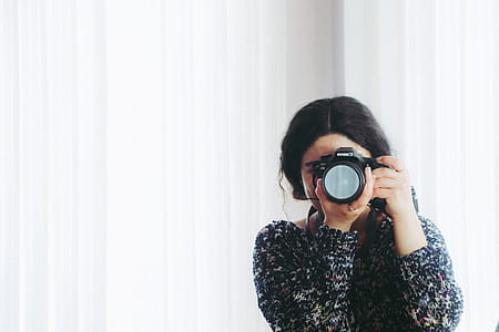 Woman in Black Long-sleeved Shirt Using Camera thumbnail