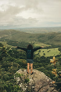Woman in Black Long-sleeved Top With Blue Denim Shorts thumbnail