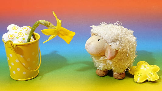 sheep plush toy looking at yellow artificial flower on steel pot thumbnail