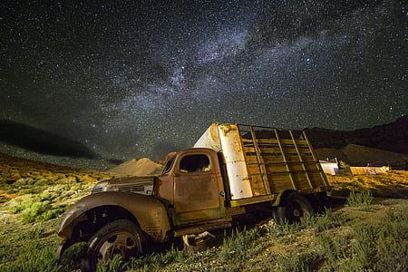 brown utility truck on green grass during nighttime thumbnail