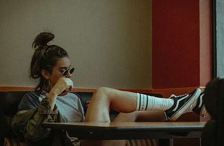 woman sitting on bench in front of table thumbnail