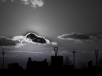 high-rise buildings over clouds grayscale photo thumbnail