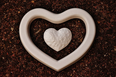 white heart ornament on brown surface thumbnail