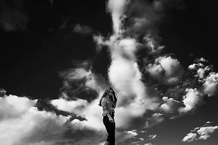 grayscale photography of woman with clouds on background thumbnail