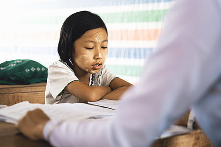 girl reading book on table thumbnail