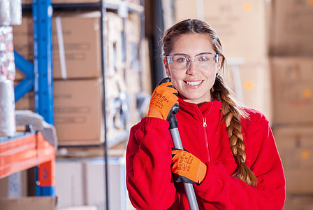 woman wearing red zip-up jacket and orange gloves and clear goggles thumbnail